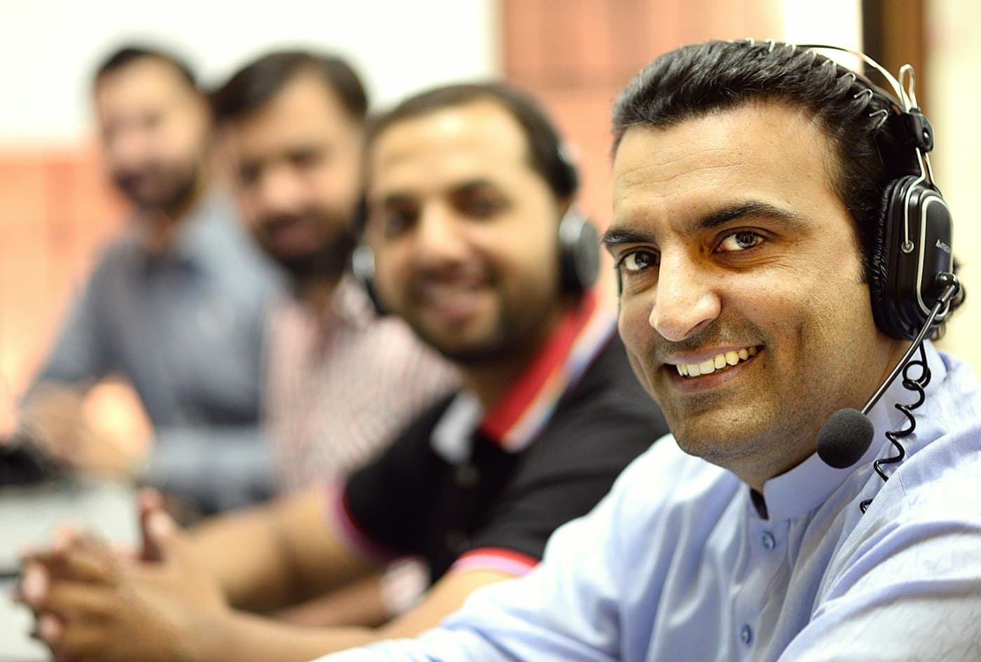 Call centre agents wearing headsets at their desks